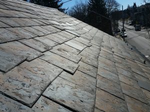 slate roof with sliding and flaking slates along with some hail damage